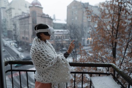 Foto de Una joven radiante disfruta del paisaje urbano invernal a través de sus gafas de realidad virtual. Foto de alta calidad - Imagen libre de derechos