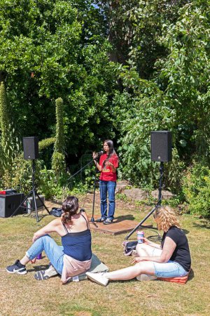 Photo for Ornithologist, environmentalist, and diversity activist Dr Mya-Rose Craig, who is also known as Birdgirl, giving a talk in Grove Park, Weston-super-Mare on 2 July 2023 - Royalty Free Image