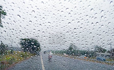 Photo for Glass rain drops texture pattern weather road traffic rainy season heavy rain storm - Royalty Free Image