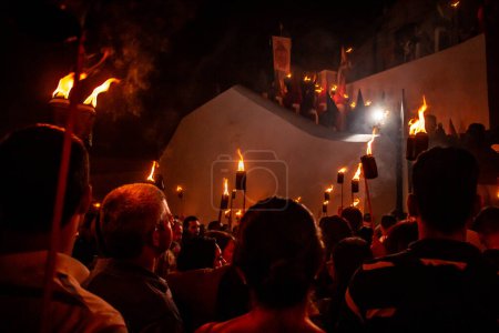 Photo for Several faithful holding fire torches during the Procession of Fogareu, a religious festival that takes place in the city of Goias. - Royalty Free Image