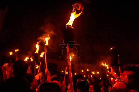 Photo for Several faithful holding fire torches during the Procession of Fogareu, a religious festival that takes place in the city of Goias. - Royalty Free Image