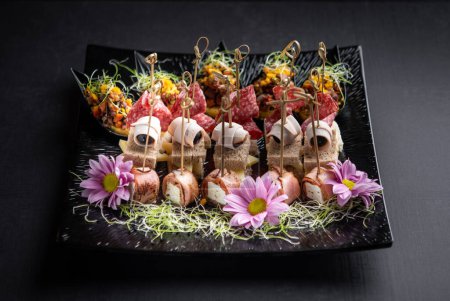 Photo for Delicious canapes served with microgreen and flowers - Royalty Free Image