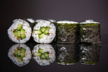 Photo for Crunchy sushi rolls with cucumber and sesame seeds - Royalty Free Image
