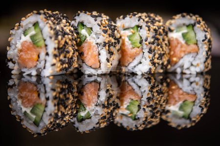 Photo for California sushi rolls with salmon, cream cheese and cucumber - Royalty Free Image
