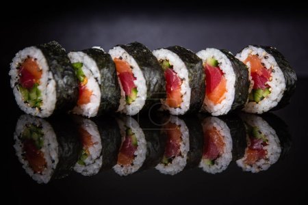 Photo for Sushi rolls with salmon, tuna and cucumber - Royalty Free Image