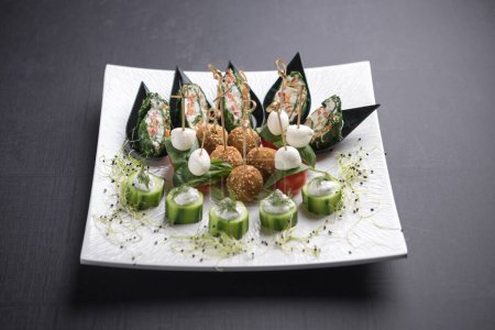 Photo for White platter with tiny canapes and falafels served with skewers - Royalty Free Image