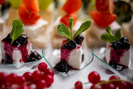 Photo for Closeup of vegetarian canapes with cheese, berries and vegetables - Royalty Free Image