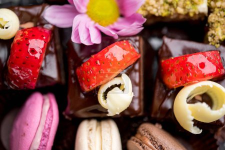 Photo for Chocolate desserts with strawberries served with macaroons - Royalty Free Image