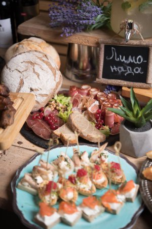 Photo for Festive table in rustic style with antipasti and drinks - Royalty Free Image
