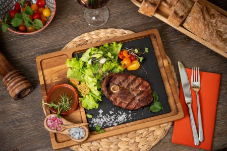 Photo for Grilled steak served with cherry tomatoes and lettuce - Royalty Free Image