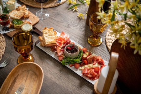 Photo for Delicious antipasti served with sauces and drinks - Royalty Free Image