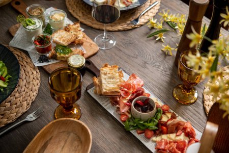 Photo for Delicious antipasti served with sauces and drinks - Royalty Free Image