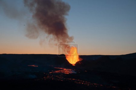 Foto de Pequeño avión volando sobre el volcán en erupción al amanecer, Geldingadal Islandia - Imagen libre de derechos