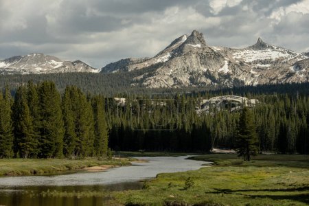 Unicorn Peak With Summer Snow Stands High Over Tuolomne River in Yosemite National Park