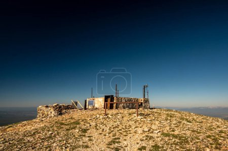 Photo for Remains Of Burned Fire Tower Below Deep Blue Sky On Mt Holmes in Yellowstone - Royalty Free Image
