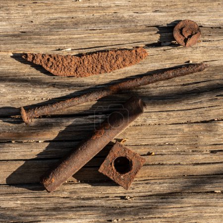 Photo for Rusty Connectors On Display on wooden surface - Royalty Free Image