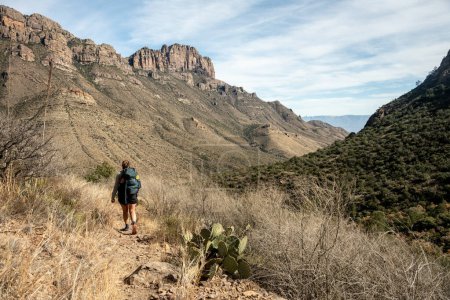 Woman Backpacks Below Casa Grande Peak on the Juniper Canyon Trail in Big Bend