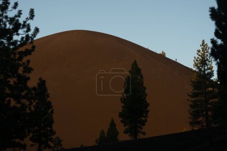 Silhouetted Pine Trees Against Cinder Cone in Lassen Volcanic