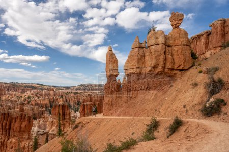 Woman Stands with Excitement at Curve of Trail in Bryce Canyon