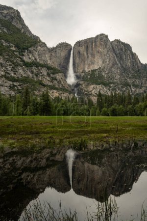 Rushing Yosemite Falls Reflects in Merced river in Summer