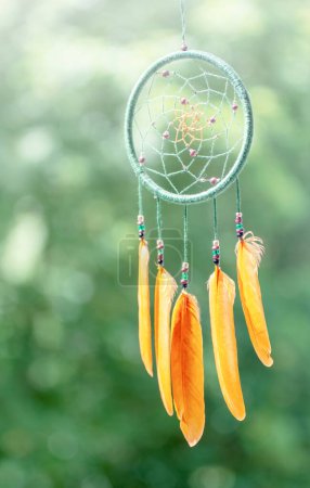 Dream catcher with feathers threads and beads rope hanging.