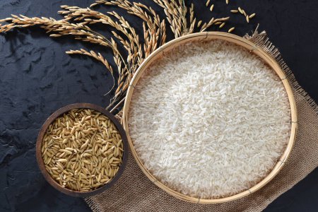 Paddy and rice in baskets placed on a black background.