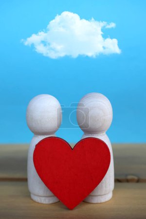 Photo for Two wooden figures with red heart and a cloud above them - Royalty Free Image