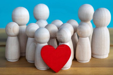 group of wooden figures with a red heart and blue background