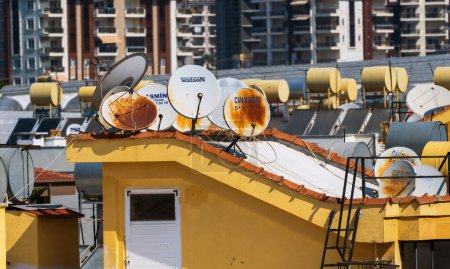 Photo for Antalya, Turkey - September 11, 2021: Bunch of old dish antenna on a roof of apartments - Royalty Free Image