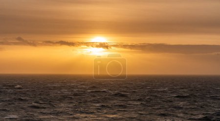 Photo for Rough weather off the lighthouse at sunset Isle of Anglesey North Wales - Royalty Free Image
