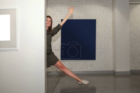 Photo for Young woman in an art gallery. Woman having fun in art gallery - Royalty Free Image