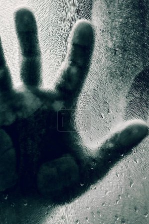 Photo for Mans figure with hands pressed against frosted glass. Shadow of a man behind the matte glass blurry hand and body soft focus. Freedom concept - Royalty Free Image