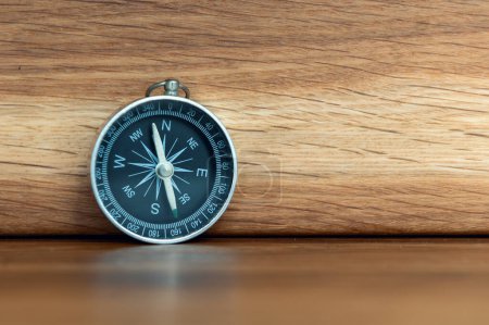 Photo for Compass on wooden background with copy space using as direction - Royalty Free Image