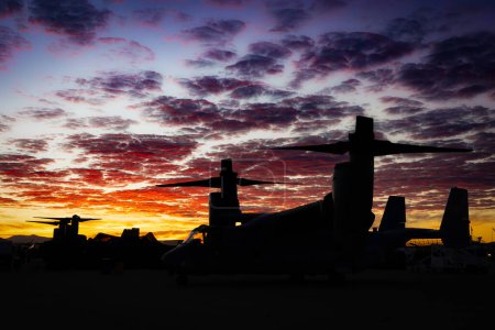 Photo for The sun rises behind a V-22 Osprey, before the crowds arrive, at the 2022 Miramar Airshow in San Diego, California. - Royalty Free Image