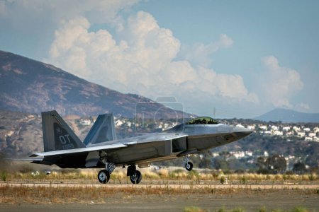 Photo for Heat rises from the runway as an F-22 Raptor lands at the 2022 Miramar Airshow. - Royalty Free Image