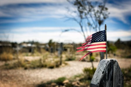 Photo for A tattered American flag attached to a grave marker at Boothill in Tombstone, Arizona. - Royalty Free Image