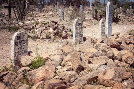 Photo for Boothill in Tombstone, Arizona became a nickname for the "Old City Cemetery" referencing the number of men who died with their boots on.  These are the graves of Billy Clanton, Frank McLaury, and Frank McLaury killed by the Earp Brothers and Doc Holl - Royalty Free Image