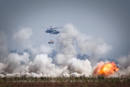 Photo for A Marine Corps CH-53, appears in the distance through the smoke, during the Marine Air Ground Task Force (MAGTF) Demstration at the 2023 America's Airshow at Miramar, California. - Royalty Free Image