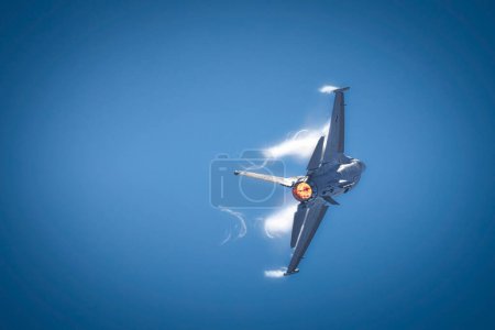 Photo for Vapor breaks around an F-16, part of the Viper Demonstration Team, at America's Airshow 2023 in Miramar, California. - Royalty Free Image