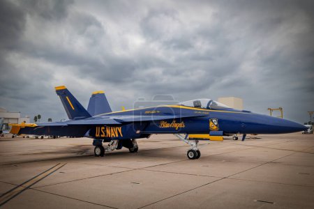 Photo for Number One of the US Navy Blue Angels sits on the tarmac with storm clouds in the background at America's Airshow 2023 in Miramar, California. - Royalty Free Image