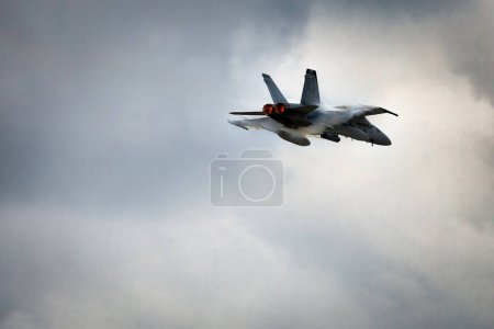 Photo for Vapor breaks around an F-18 Hornet, part of the Marine Air Ground Task Force (MAGTF) demonstration at America's Airshow 2023 in Miramar, California. - Royalty Free Image