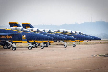 Photo for The US Navy Blue Angels sit on the flightline, in the rain, at America's Airshow 2023 in Miramar, California. - Royalty Free Image