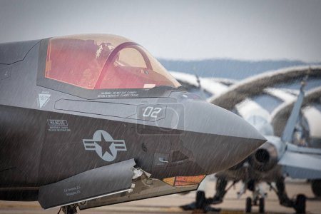 Photo for An aviators sitting in the cockpit of an F-35 Lightning II, while it rains, at America's Airshow 2023 in Miramar, California. - Royalty Free Image