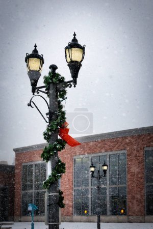 Photo for Christmas decorations during a snowstorm in the downtown area of Manitowoc, Wisconsin. - Royalty Free Image