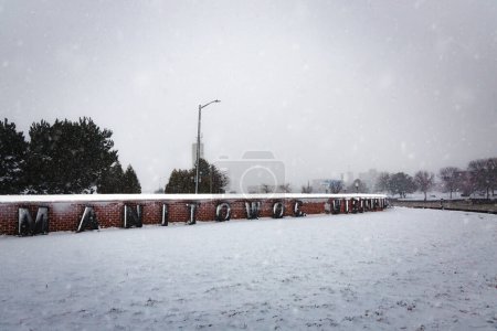 Photo for A blizzard at the Manitowoc, Wisconsin sign that welcomes summer car ferry tourists to the city. - Royalty Free Image