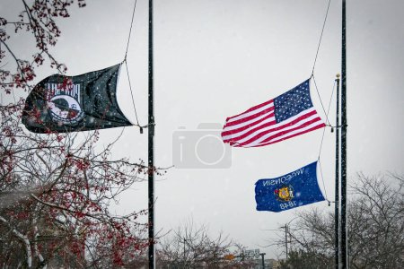Photo for Flags at half-mast in Manitowoc, Wisconsin during a snow storm. - Royalty Free Image