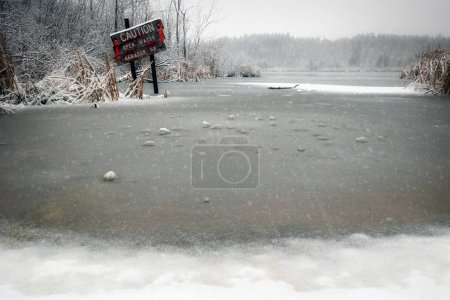 Photo for Winter ice forms at the dock area of Weyers Lake near Manitowoc, Wisconsin. - Royalty Free Image