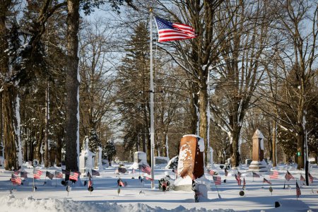 Photo for Fresh snowfall at the Union soldier graves belonging to the Grand Army of the Republic from the Civil War at a northern Wisconsin cemetery. - Royalty Free Image
