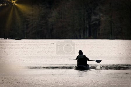 Photo for A kayaker paddles on Stumpy Lake near Virginia Beach, Virginia. - Royalty Free Image