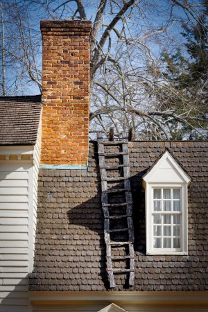 Photo for A ladder attached to a roof on a building at Colonial Williamsburg, Virginia. - Royalty Free Image
